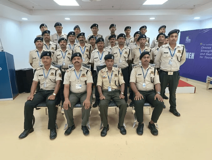Professional group photograph of SUN SECURITY SERVICES team in indoor setting